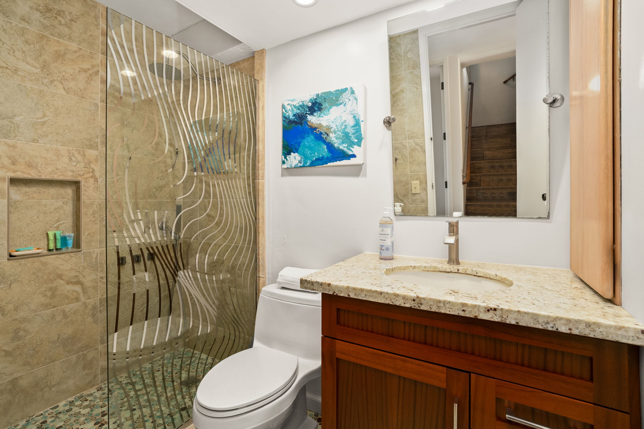 3811 Edward Road, Unit 8204 Princeville, HI 96722 - Photo 17 of 29 a bathroom with a granite countertop sink a toilet and a mirror