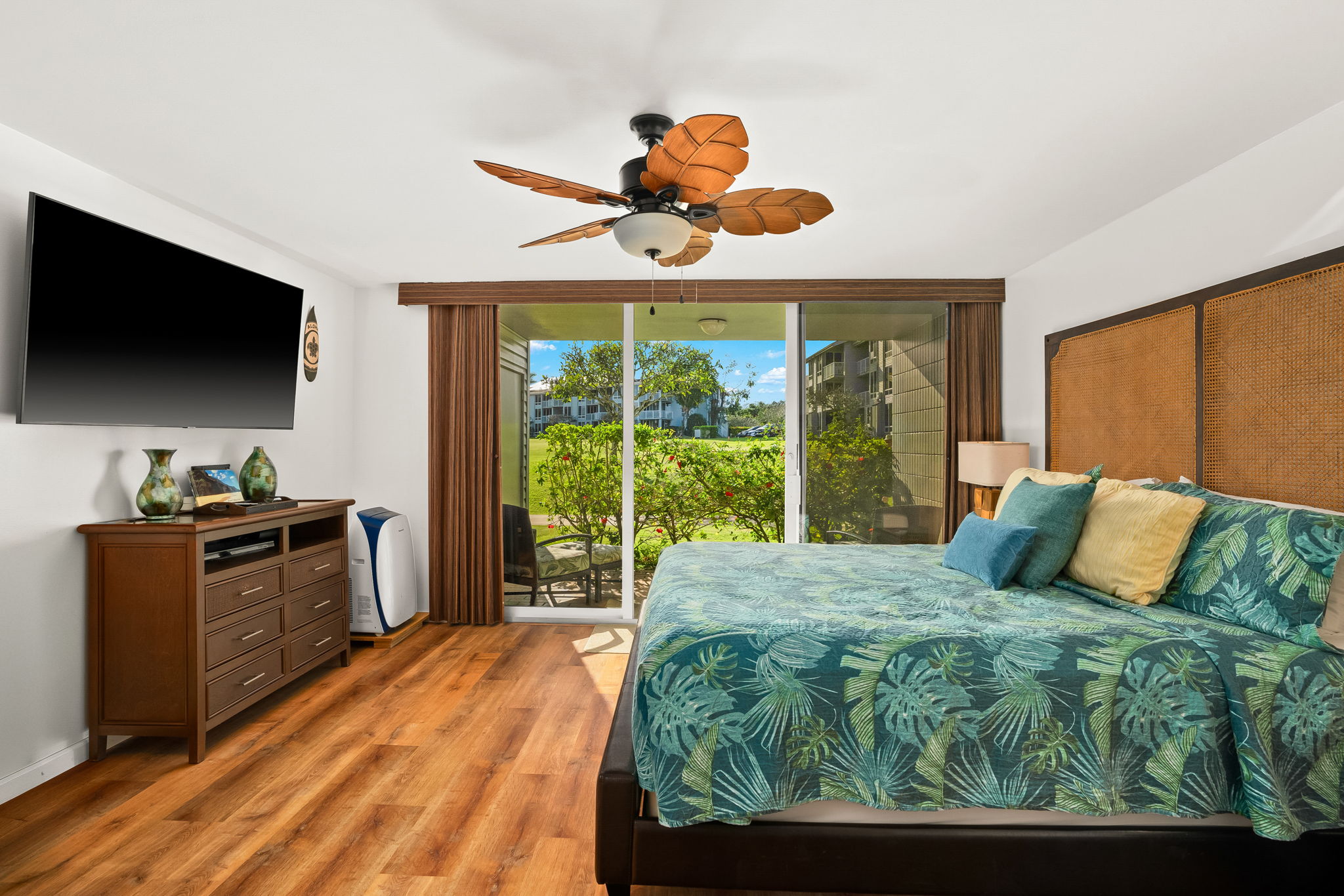 3811 Edward Road, Unit 8204 Princeville, HI 96722 - Photo 18 of 29 a bed room with a bed television and a large window