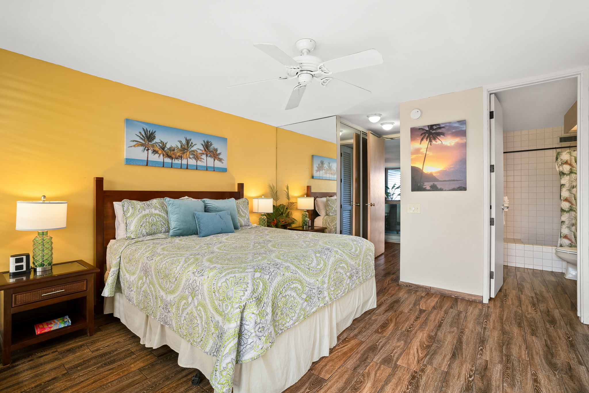 3811 Edward Road, Unit 8204 Princeville, HI 96722 - Photo 10 of 29 a spacious bedroom with a bed and wooden floor