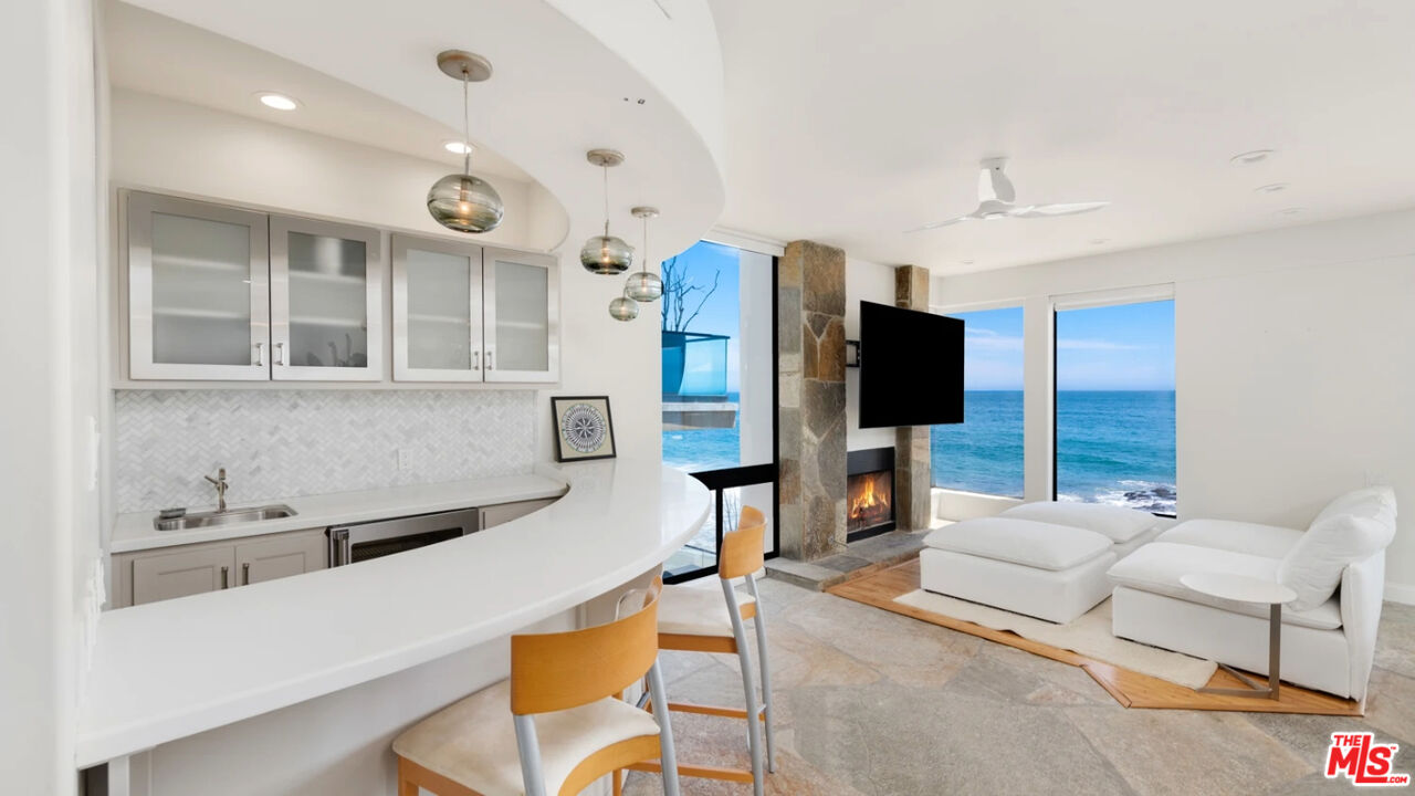 25252 Malibu Road, Unit UPPR Malibu, CA 90265 - Photo 24 of 27 a living room with furniture and a flat screen tv