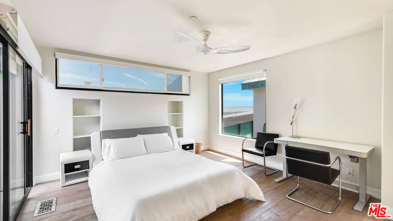 25252 Malibu Road, Unit UPPR Malibu, CA 90265 - Photo 26 of 27 a bedroom with a bed and wooden floor