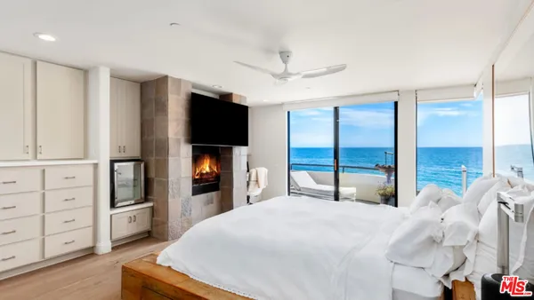 a bedroom with a large bed and a tv