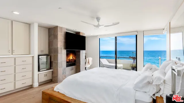 a bedroom with a large bed and a tv