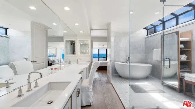 a large room with a lot of white furniture