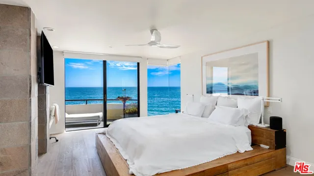 a bedroom with a large bed and a window