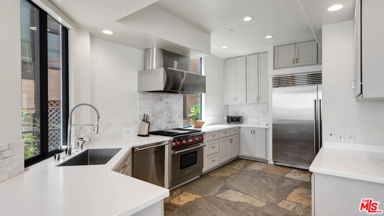 25252 Malibu Road, Unit UPPR Malibu, CA 90265 - Photo 6 of 27 a kitchen with stainless steel appliances a refrigerator sink and stove