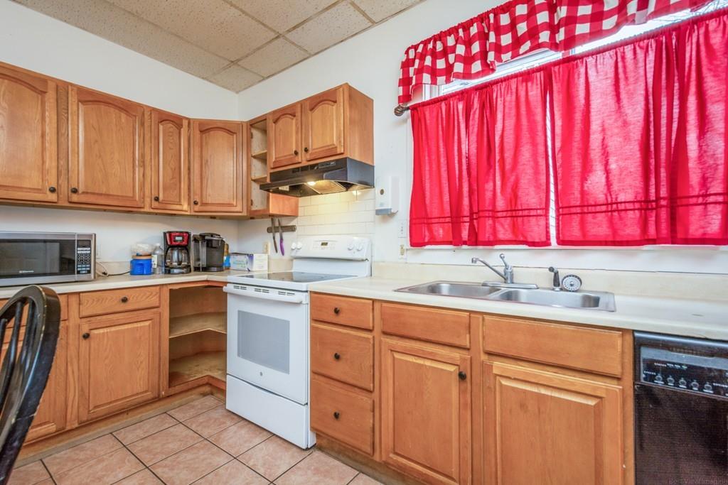 67 Congress Street Fitchburg, MA 01420 - Photo 14 of 39 a kitchen with white cabinets sink and white appliances