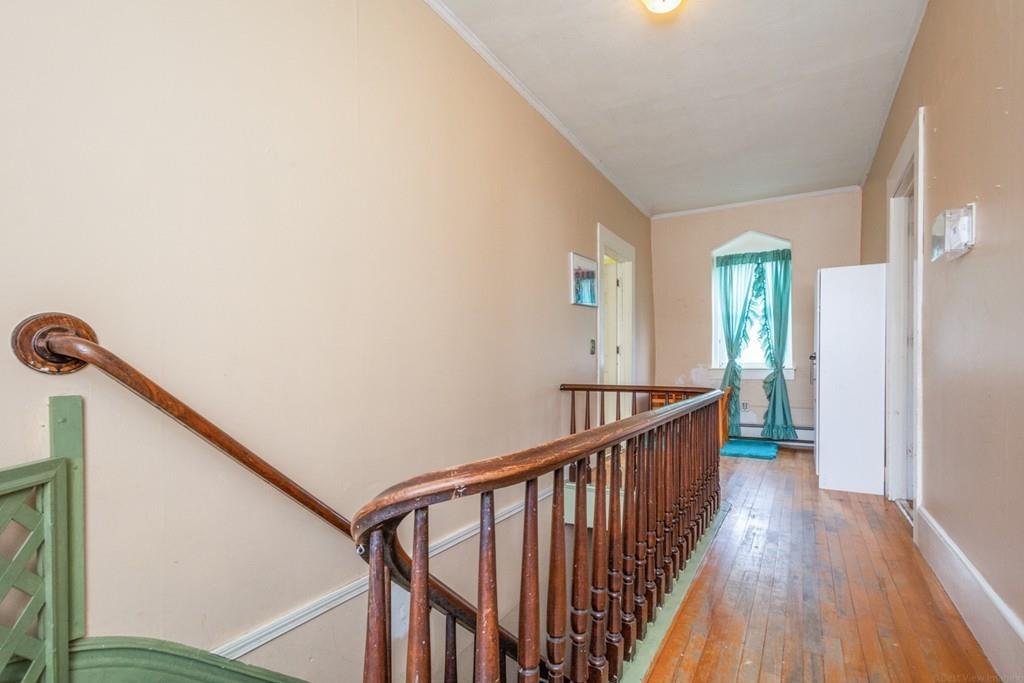 67 Congress Street Fitchburg, MA 01420 - Photo 17 of 39 a view of a hallway with wooden floor and staircase
