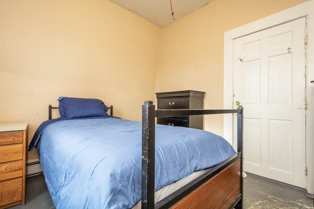 67 Congress Street Fitchburg, MA 01420 - Photo 21 of 39 a bedroom with a bed and wooden floor