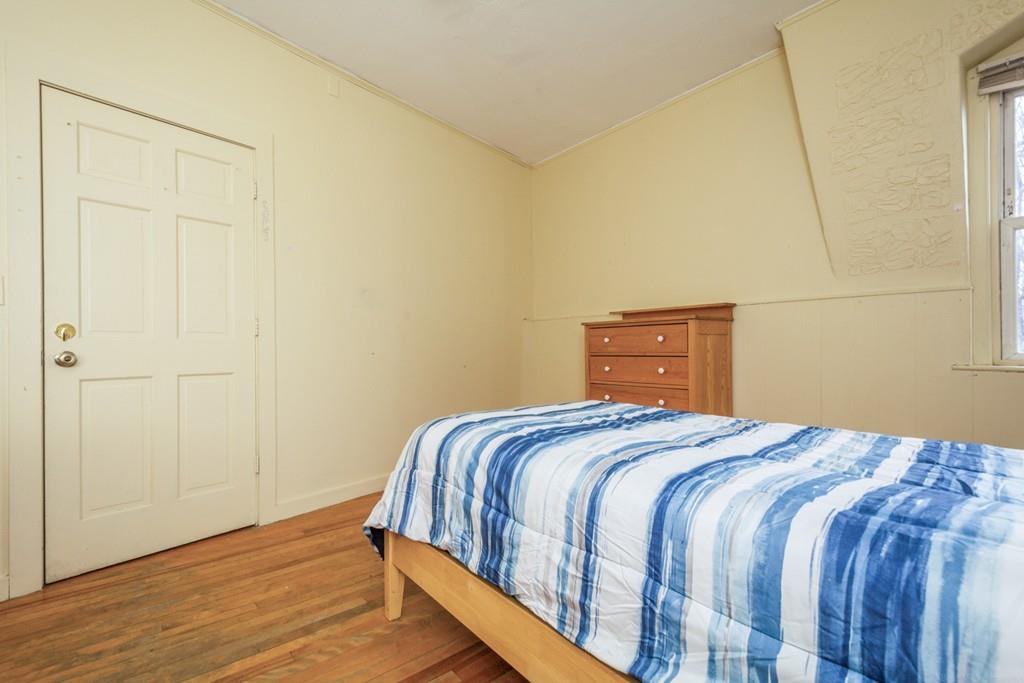 67 Congress Street Fitchburg, MA 01420 - Photo 25 of 39 a bedroom with a bed and wooden floor