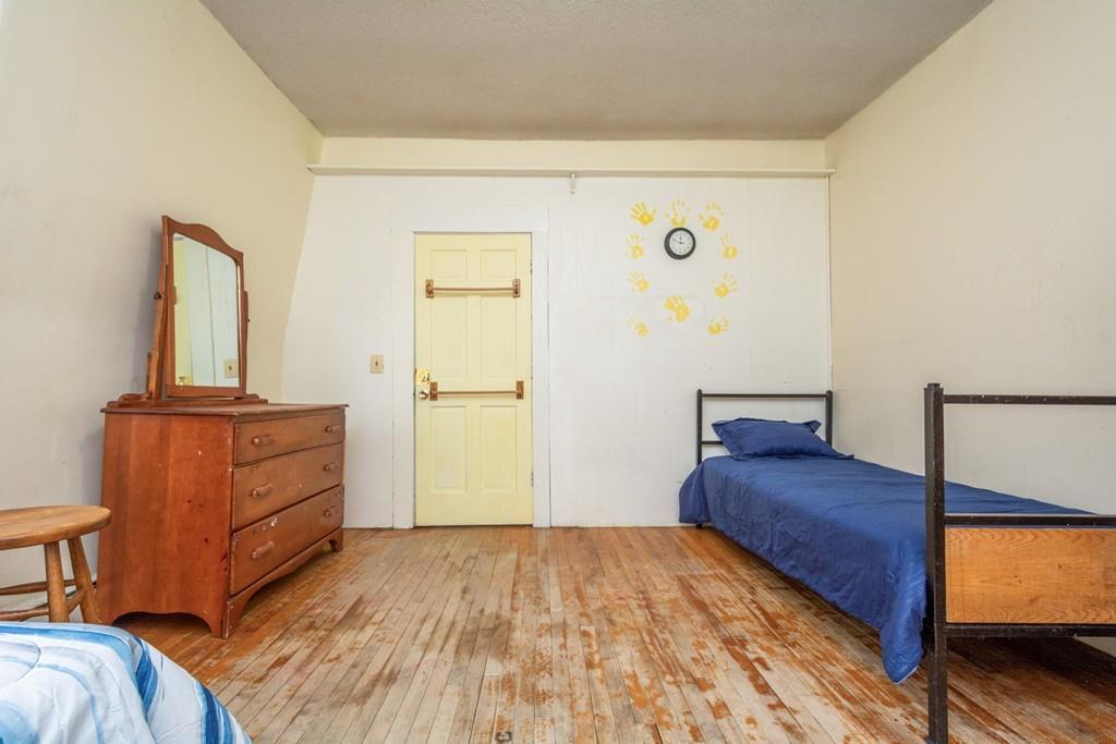 67 Congress Street Fitchburg, MA 01420 - Photo 29 of 39 a bedroom with a bed and wooden floor