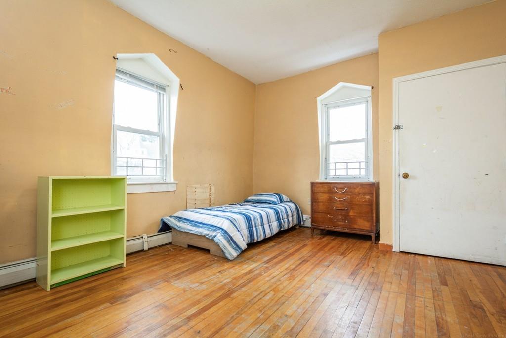 67 Congress Street Fitchburg, MA 01420 - Photo 30 of 39 a living room with a bed and a window