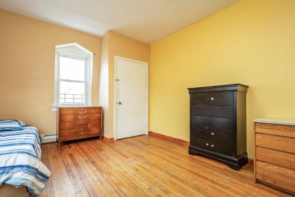 67 Congress Street Fitchburg, MA 01420 - Photo 32 of 39 a room with a bed and a dresser