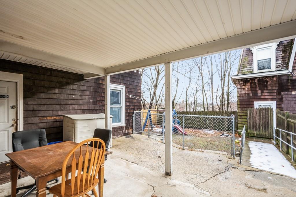 67 Congress Street Fitchburg, MA 01420 - Photo 36 of 39 a view of a patio with a table and chairs next to a yard