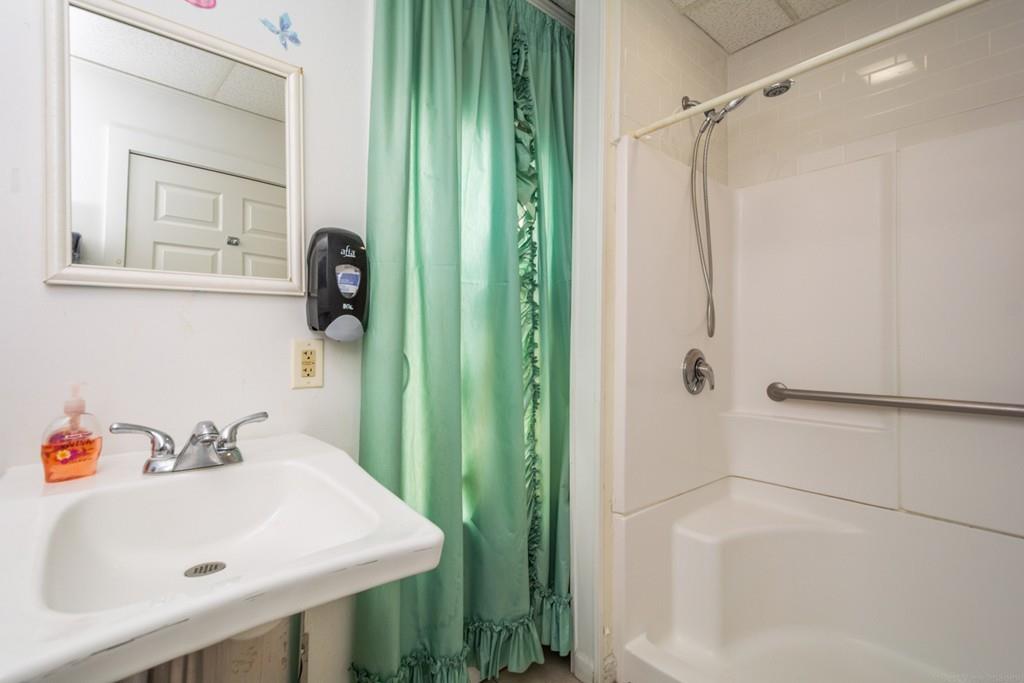 67 Congress Street Fitchburg, MA 01420 - Photo 9 of 39 a bathroom with a sink a mirror and a shower
