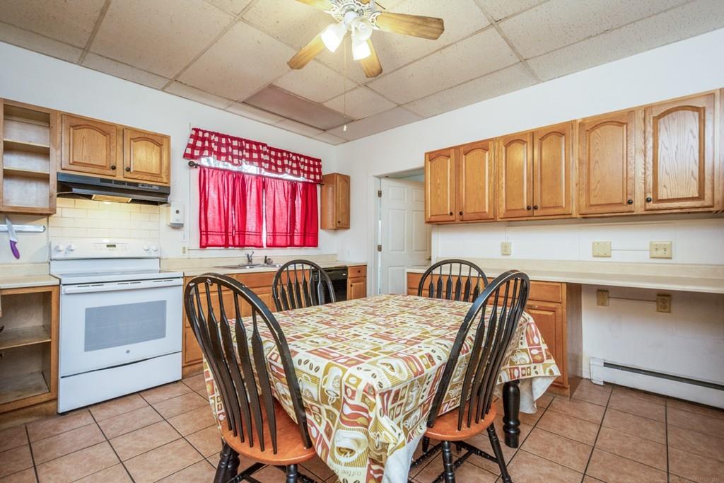 67 Congress Street Fitchburg, MA 01420 - Photo 10 of 39 a kitchen with stainless steel appliances granite countertop a sink a microwave cabinets and a dining table