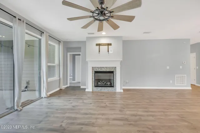 wooden floor in an empty room with a fireplace
