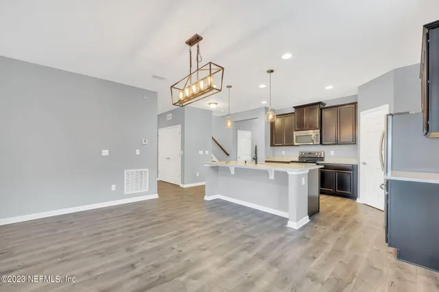 a bathroom with a sink a large mirror and vanity
