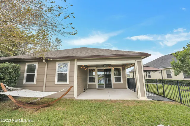 a view of a house with a backyard