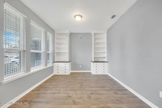 a view of a room with a window and a fireplace