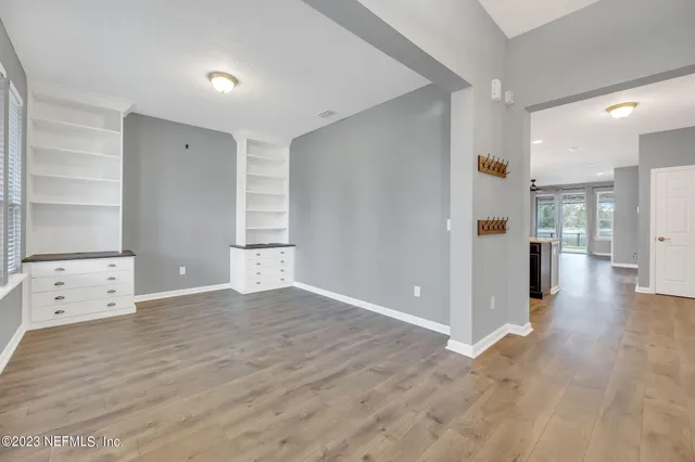 wooden floor in an empty room with a window