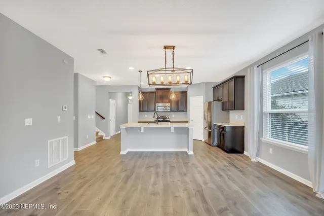 a view of a kitchen with a sink and a fireplace