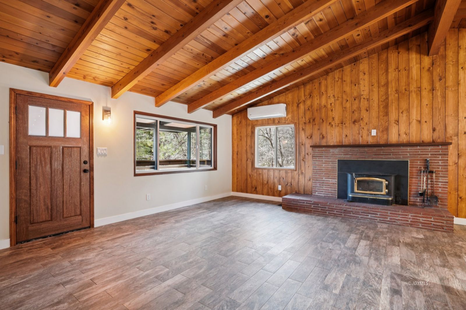 25430 Palomar Road Idyllwild, CA 92549 - Photo 37 of 38 an empty room with windows fireplace and wooden floor