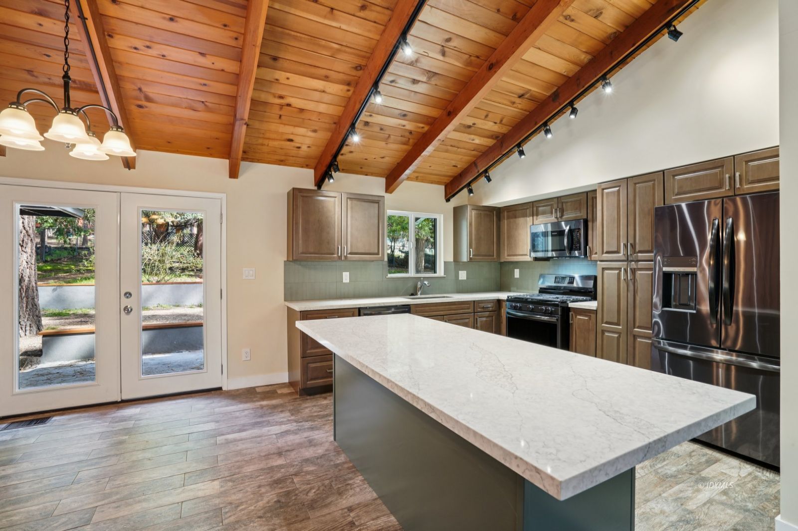 25430 Palomar Road Idyllwild, CA 92549 - Photo 5 of 38 a large kitchen with kitchen island a large counter space stainless steel appliances and cabinets