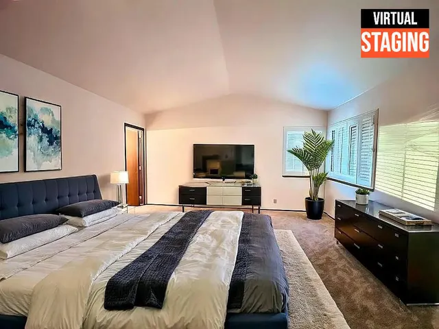 a bedroom with a bed and a flat screen tv