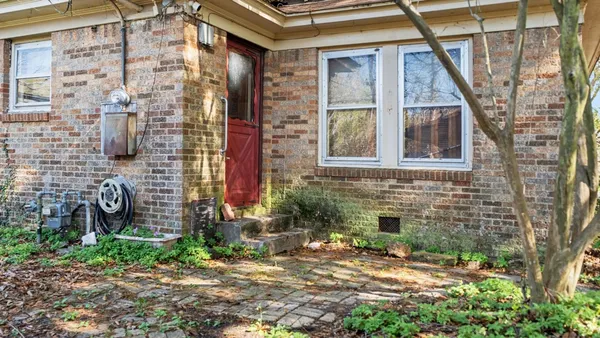 a front view of a house with a yard