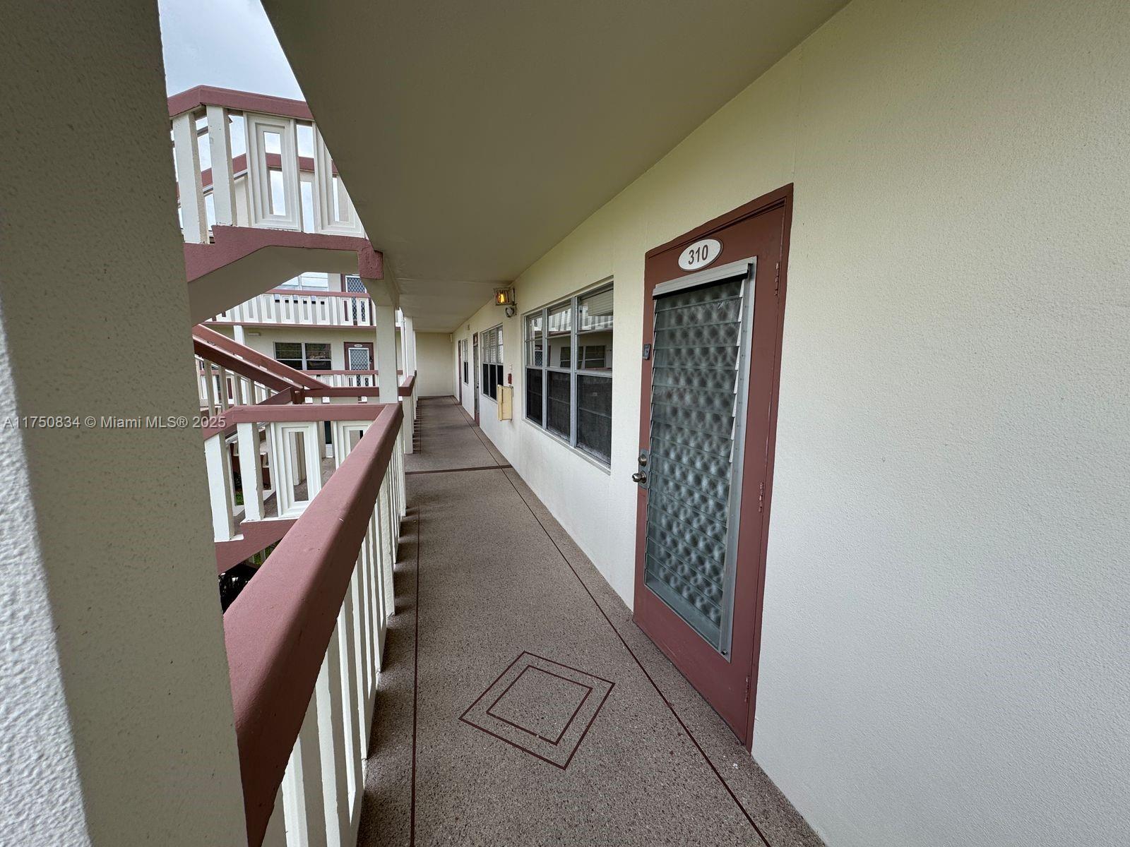 310 Preston H, Unit 310 Boca Raton, FL 33434 - Photo 14 of 21 a view of staircase with wooden floor and windows