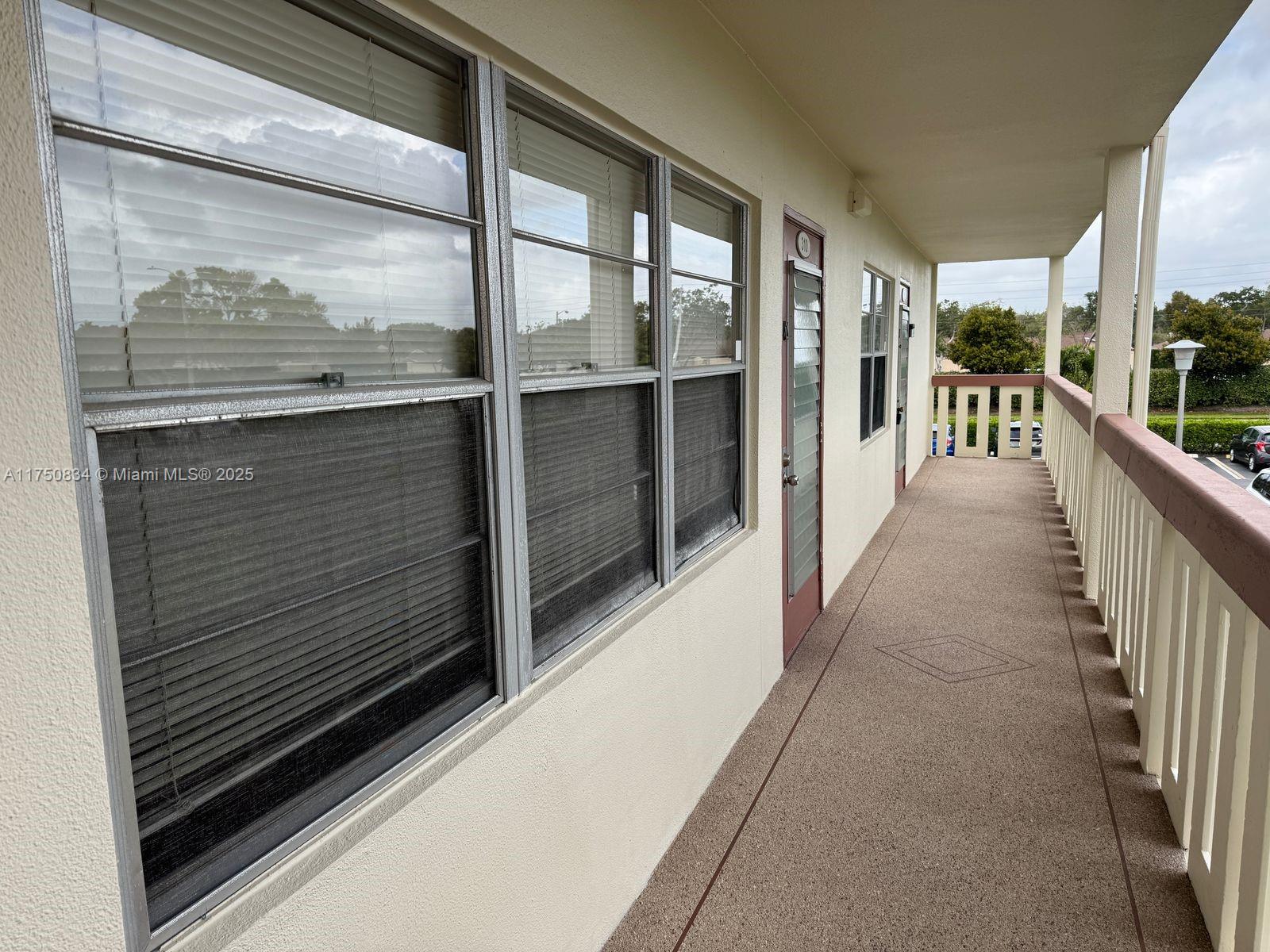 310 Preston H, Unit 310 Boca Raton, FL 33434 - Photo 3 of 21 a view of a glass door with a balcony