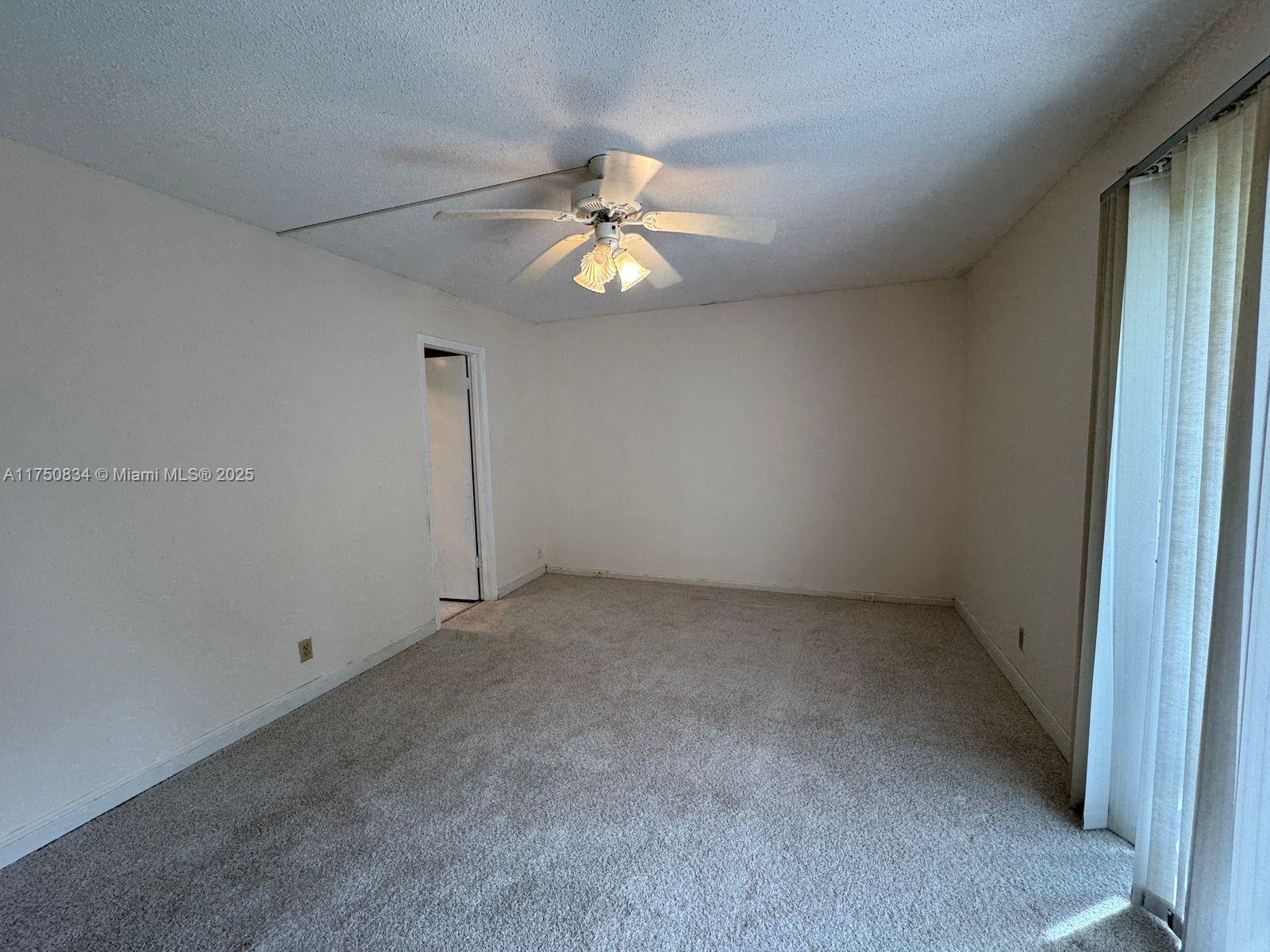 310 Preston H, Unit 310 Boca Raton, FL 33434 - Photo 7 of 21 an empty room with closet and a chandelier fan