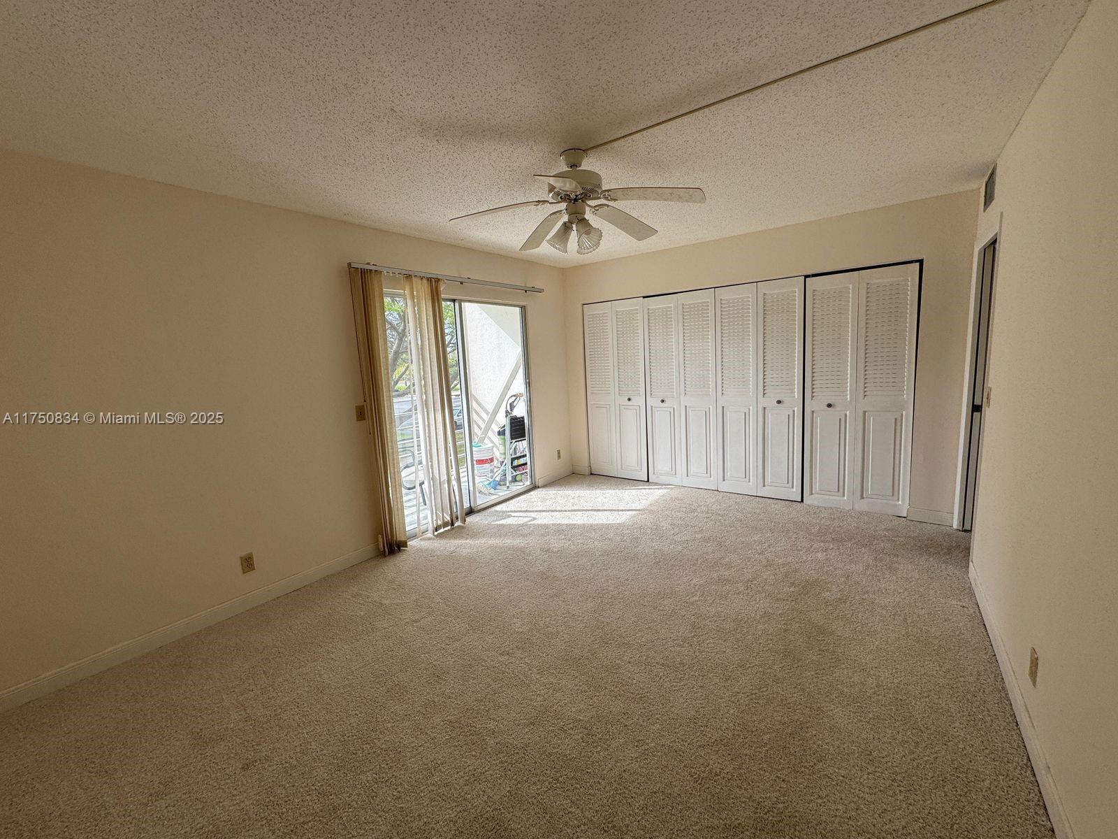 310 Preston H, Unit 310 Boca Raton, FL 33434 - Photo 9 of 21 an empty room with windows and fan