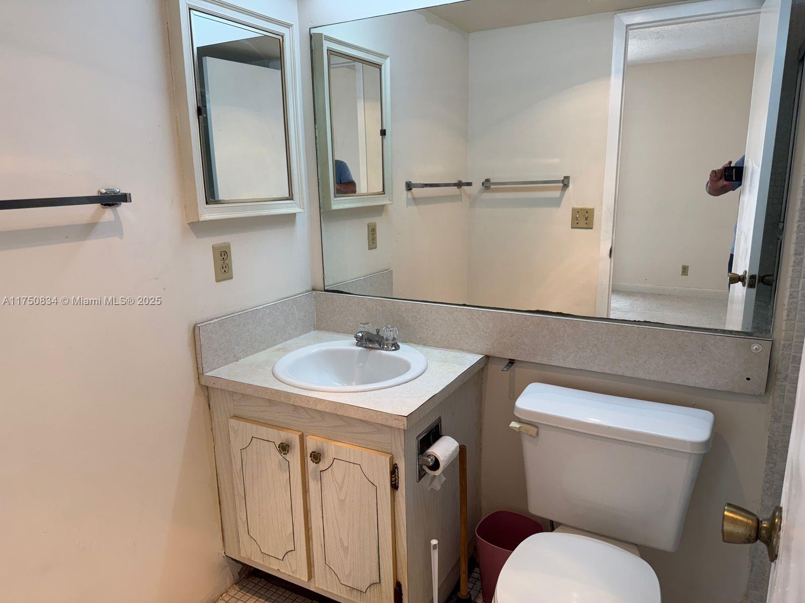 310 Preston H, Unit 310 Boca Raton, FL 33434 - Photo 10 of 21 a bathroom with a sink toilet and mirror