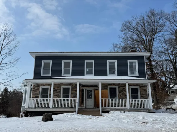 a view of a house with large windows