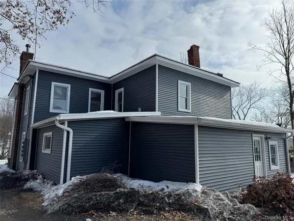 a side view of a house with a yard