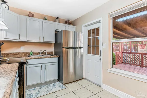 a kitchen with stainless steel appliances granite countertop a refrigerator and a stove