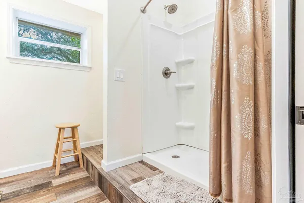 a bathroom with a bathtub and shower