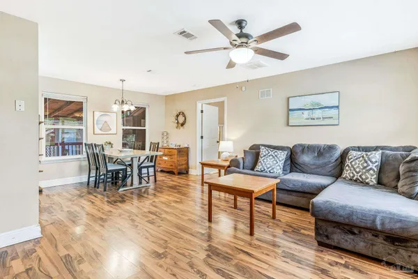 a living room with furniture and wooden floor