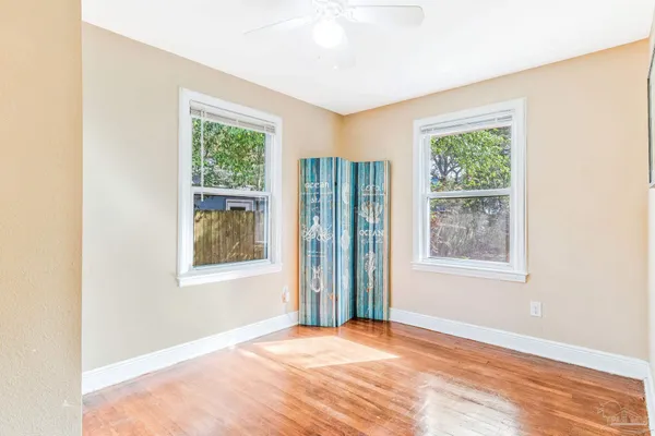 wooden floor in an empty room with a window
