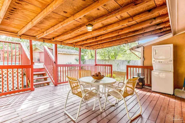 a view of a patio with a table and chairs