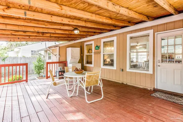 a view of yard with deck and wooden fence