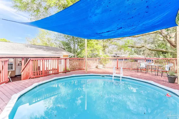 swimming pool view with a seating space