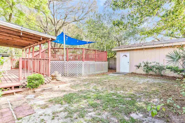 a view of a house with a yard and sitting area