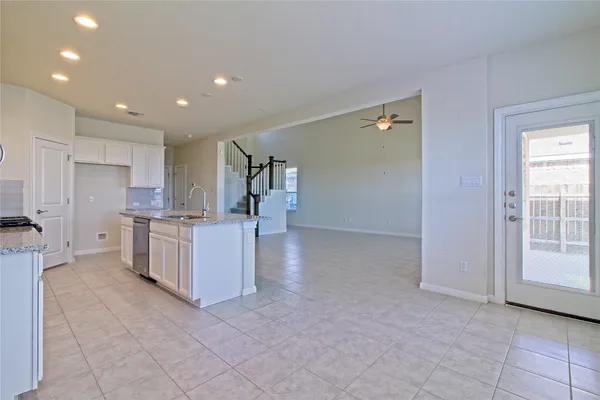 a view of a kitchen with refrigerator and window