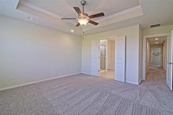 wooden floor in an empty room and a ceiling fan