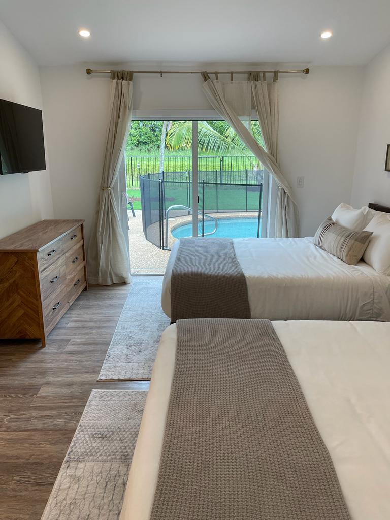 7360 San Sebastian Drive Boca Raton, FL 33433 - Photo 12 of 27 a bedroom with a large bed and a large window