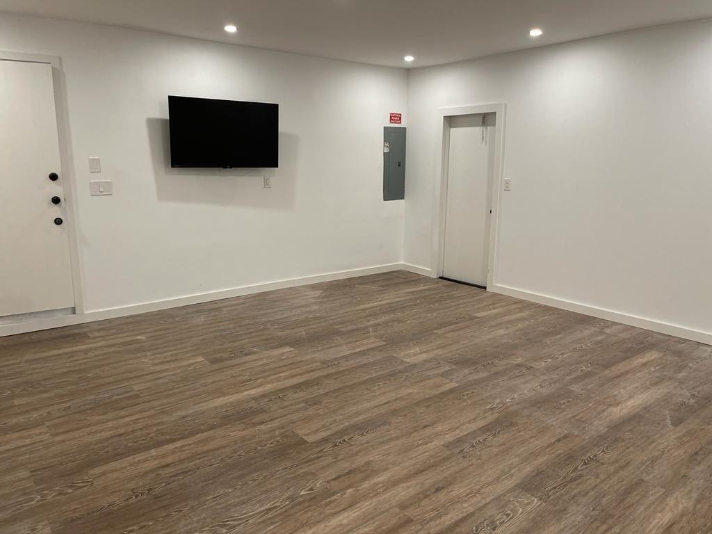 7360 San Sebastian Drive Boca Raton, FL 33433 - Photo 23 of 27 an empty room with wooden floor and windows