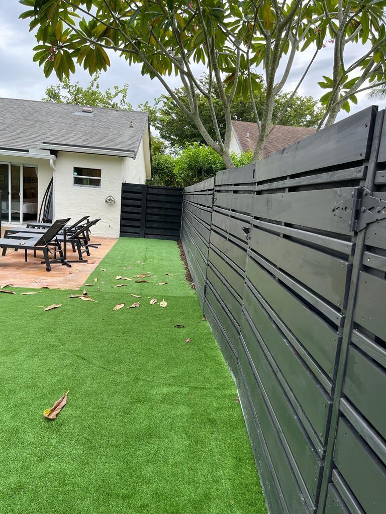 7360 San Sebastian Drive Boca Raton, FL 33433 - Photo 25 of 27 a view of backyard with table and chairs and a barbeque